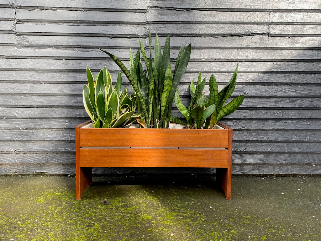 The perfect touch for any room. The original styrofoam inserts accommodate three medium-sized plants. Makeshift wood lid that can transform this unit into a small side table or storage bin- Cook Street Vintage