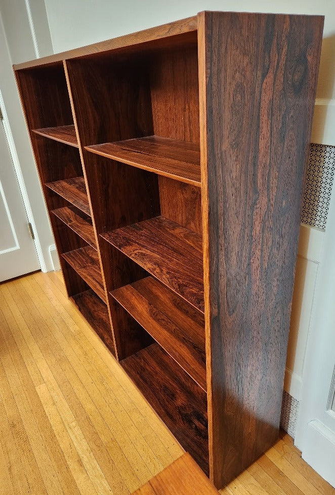 Beautiful rosewood book shelves with 7 adjustable shelves.  Works well on its own or on top our matching credenza. Made in Denmark by Poul Dogvad for Hundevad & Co.- Cook Street Vintage