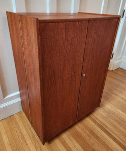 Magic Box Desk closed multifunctional teak folding desk designed by Swiss architects Ernst Mummenthaler and Otto Meier to resemble a cabinet. This midcentury piece opens to reveal numerous adjustable shelves and a drawer that pulls out to create the perfect work surface for your laptop or for writing. A retractable reading lamp automatically turn son when you pull it out.&nbsp; &nbsp;Recently restored, it comes with a set of keys to lock the unit once closed.- Cook Street Vintage