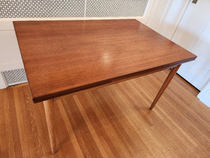 MCM Perfect size Danish extending teak dining table for a smaller space. At only 48"L, the table can extend up to 79"L with the two hidden leaves. Classic design with continuous grain and tapered legs. Made in Denmark by Farstrup- Cook Street Vintage