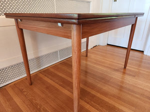 Perfect size Danish extending teak dining table for a smaller space. At only 48"L, the table can extend up to 79"L with the two hidden leaves. Classic design with continuous grain and tapered legs. Made in Denmark by Farstrup- Cook Street Vintage