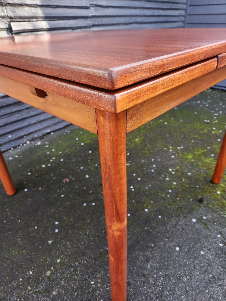 Edge of MCM teak dining tbale with extending leaves- Cook Street Vintage