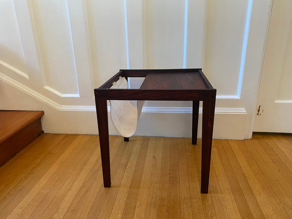 Stunning midcentury rosewood side table with canvas magazine and book sling.- Cook Street Vintage 