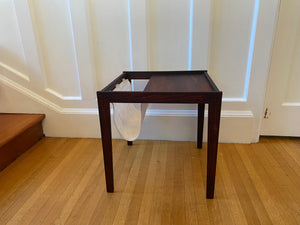 Stunning midcentury rosewood side table with canvas magazine and book sling.- Cook Street Vintage 
