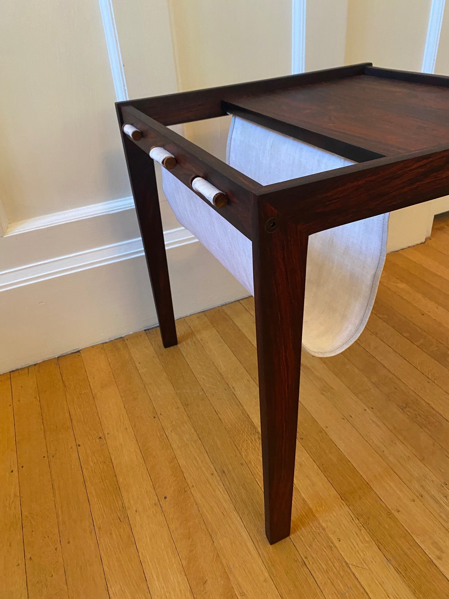 Side canvase magazine sling to Stunning midcentury rosewood side table with canvas magazine and book sling.- Cook Street Vintage 