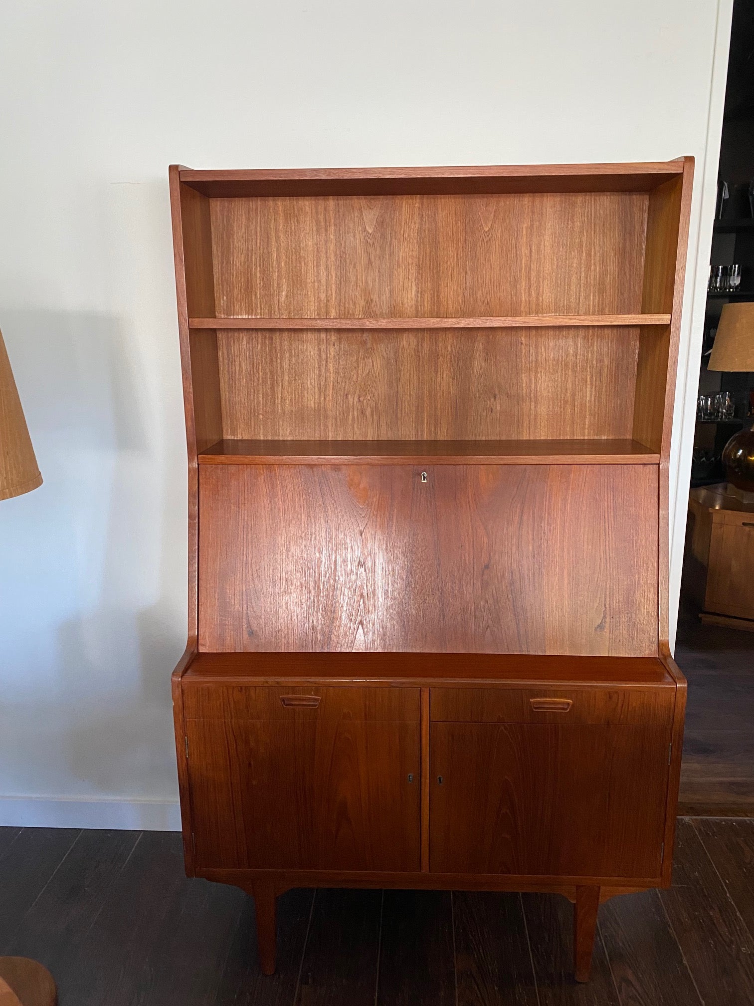 Gorgeous teak secretary with drop-down desk. Multiple storage drawers with dovetail joinery and adjustable shelves. Made in Denmark- Cook Street Vintage