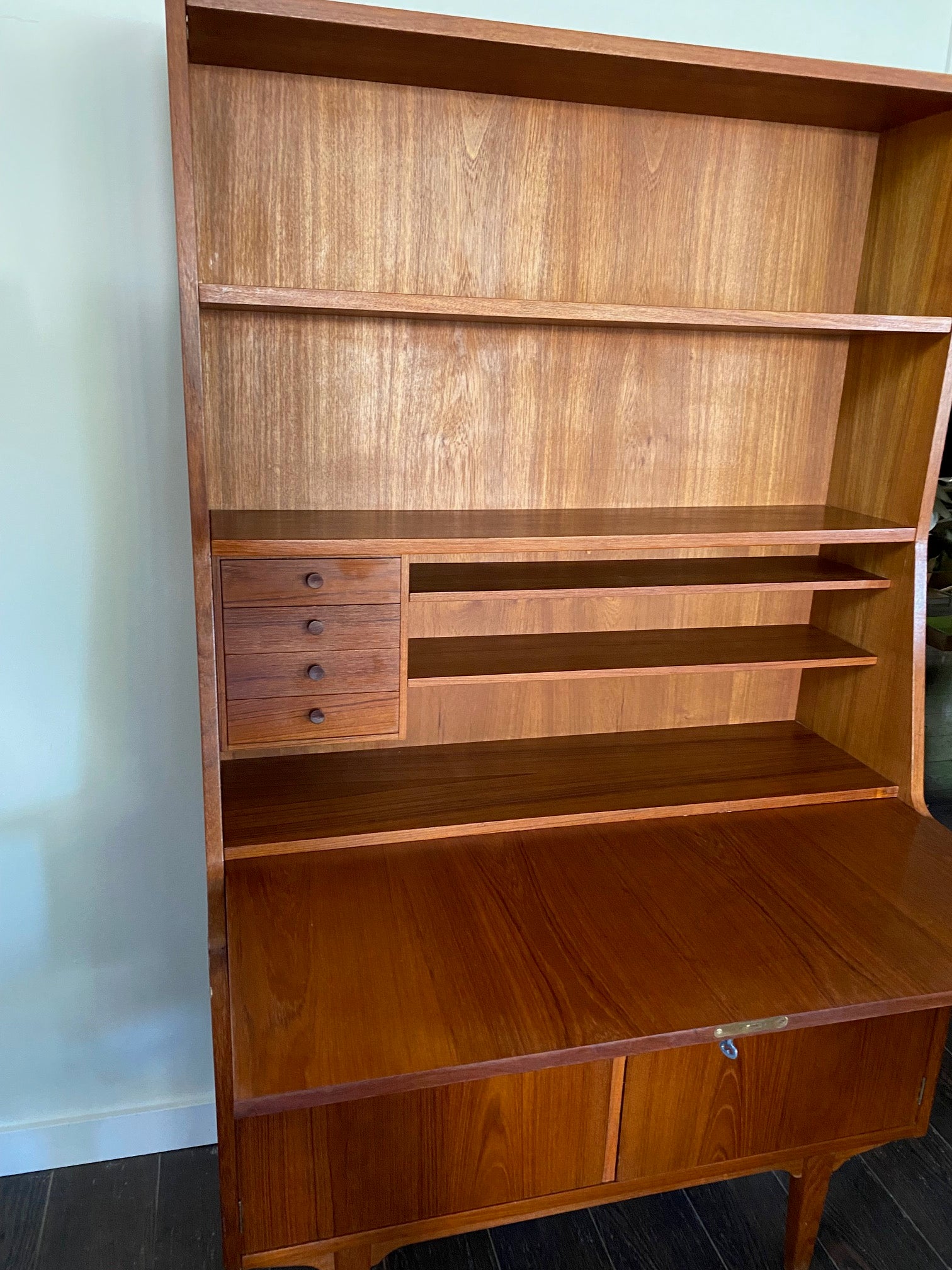 Gorgeous teak secretary with drop-down desk. Multiple storage drawers with dovetail joinery and adjustable shelves. Made in Denmark- Cook Street Vintage