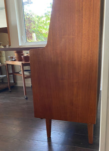 Side view of Gorgeous teak secretary with drop-down desk. Multiple storage drawers with dovetail joinery and adjustable shelves. Made in Denmark- Cook Street Vintage