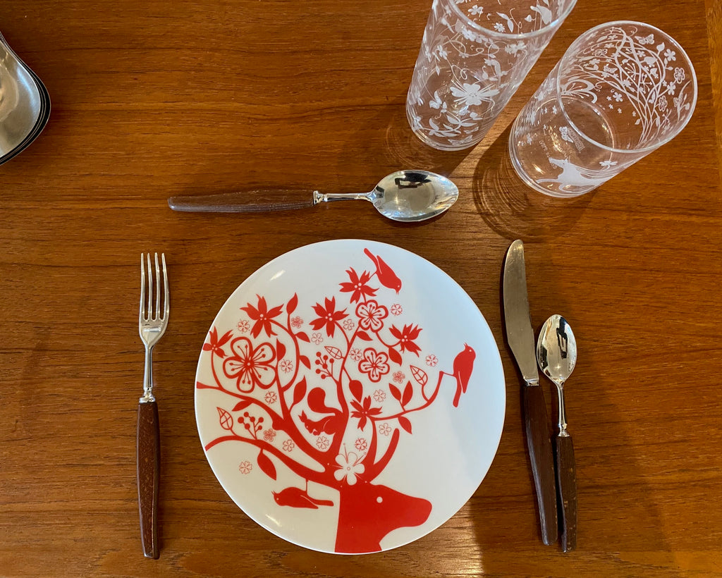 Red and white plate with deer head and flora, Tord Boontje "Table Stories" 2005  plate. Shown with our Tord Boontje highball and Tord Boontje lowball glasses, and our Glosswood cutlery-Cook Street Vintage