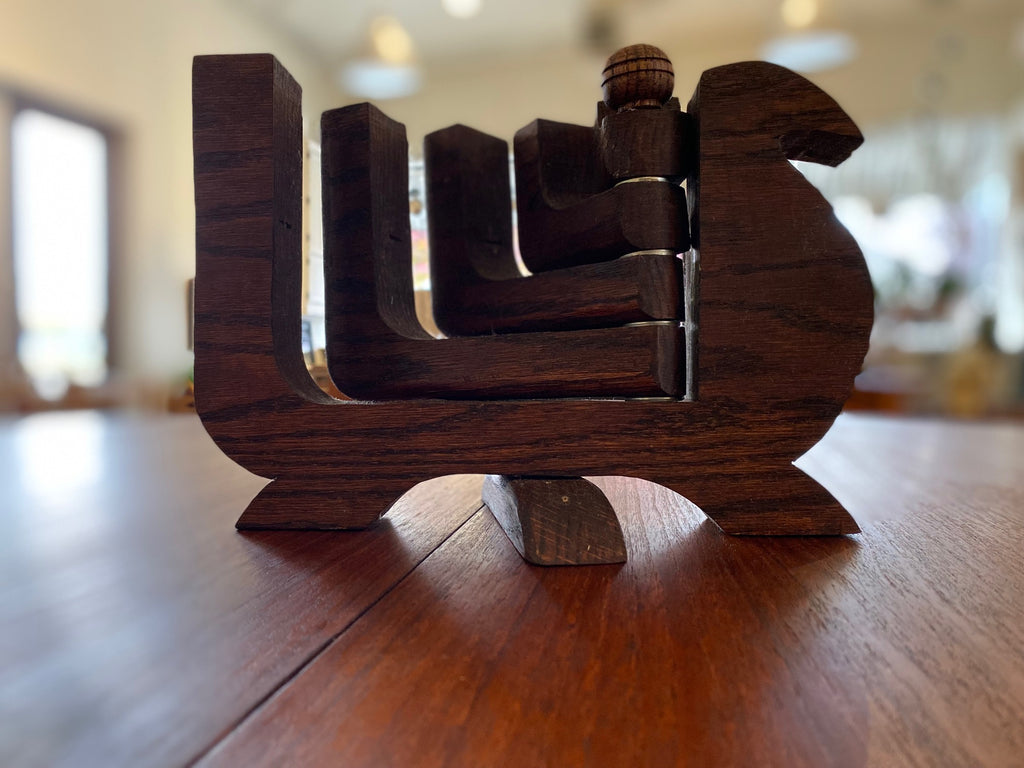 Mid-century wood 5 arm candelabra attributed to Don Shoemaker. This lovely 1970s candleholder has a burn mark on the second arm. Each arm can be splayed to either side of the dove- Cook Street Vintage