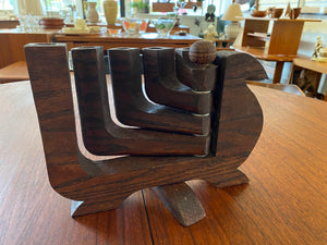 Mid-century wood 5 arm candelabra attributed to Don Shoemaker. This lovely 1970s candleholder has a burn mark on the second arm. Each arm can be splayed to either side of the dove- Cook Street Vintage
