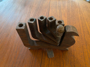 Mid-century wood 5 arm candelabra attributed to Don Shoemaker. This lovely 1970s candleholder has a burn mark on the second arm. Each arm can be splayed to either side of the dove- Cook Street Vintage