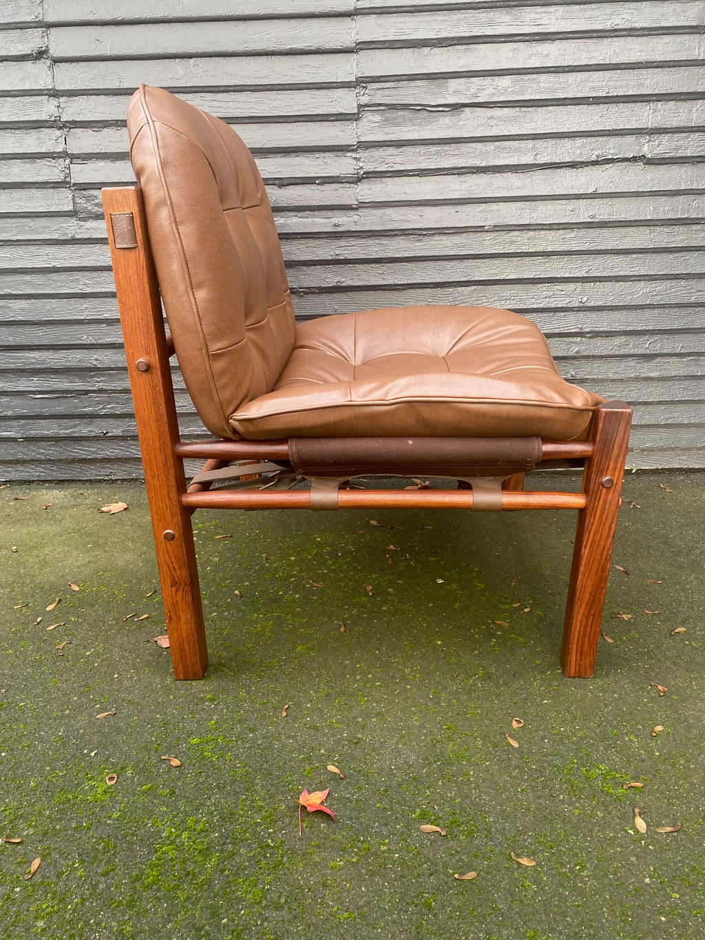 Arne Norell armless hunting chair in rosewood with original straps and supports. Newly recovered cushions and foam in brown vinyl. Imported by Scanform Colombia. Made in Medellin, Colombia- Cook Street Vintage