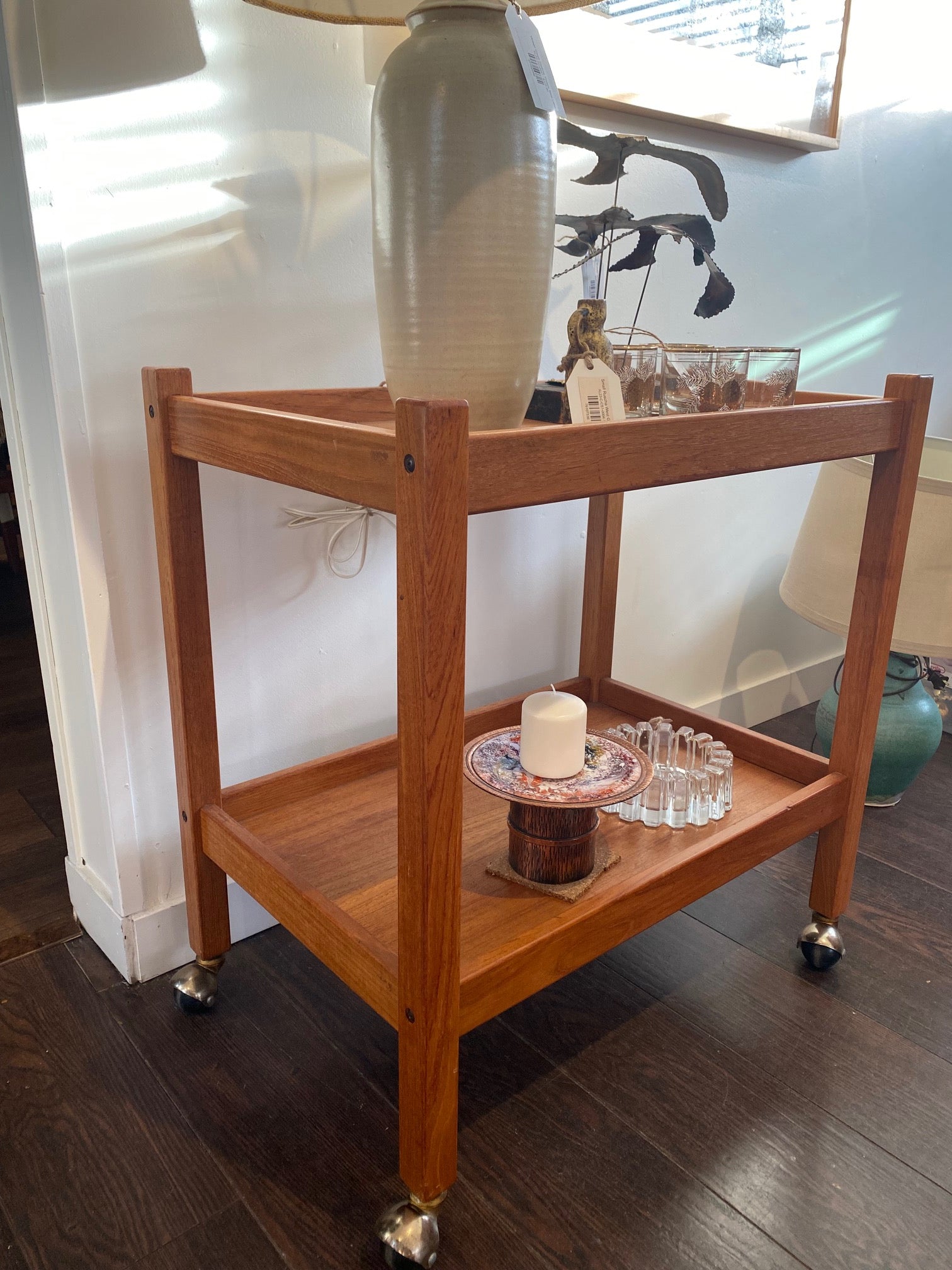 Beautiful mid-century teak cocktail bar cart on casters. A nice side table or trolley that can easily transport your glassware or dishes- Cook Street Vintage