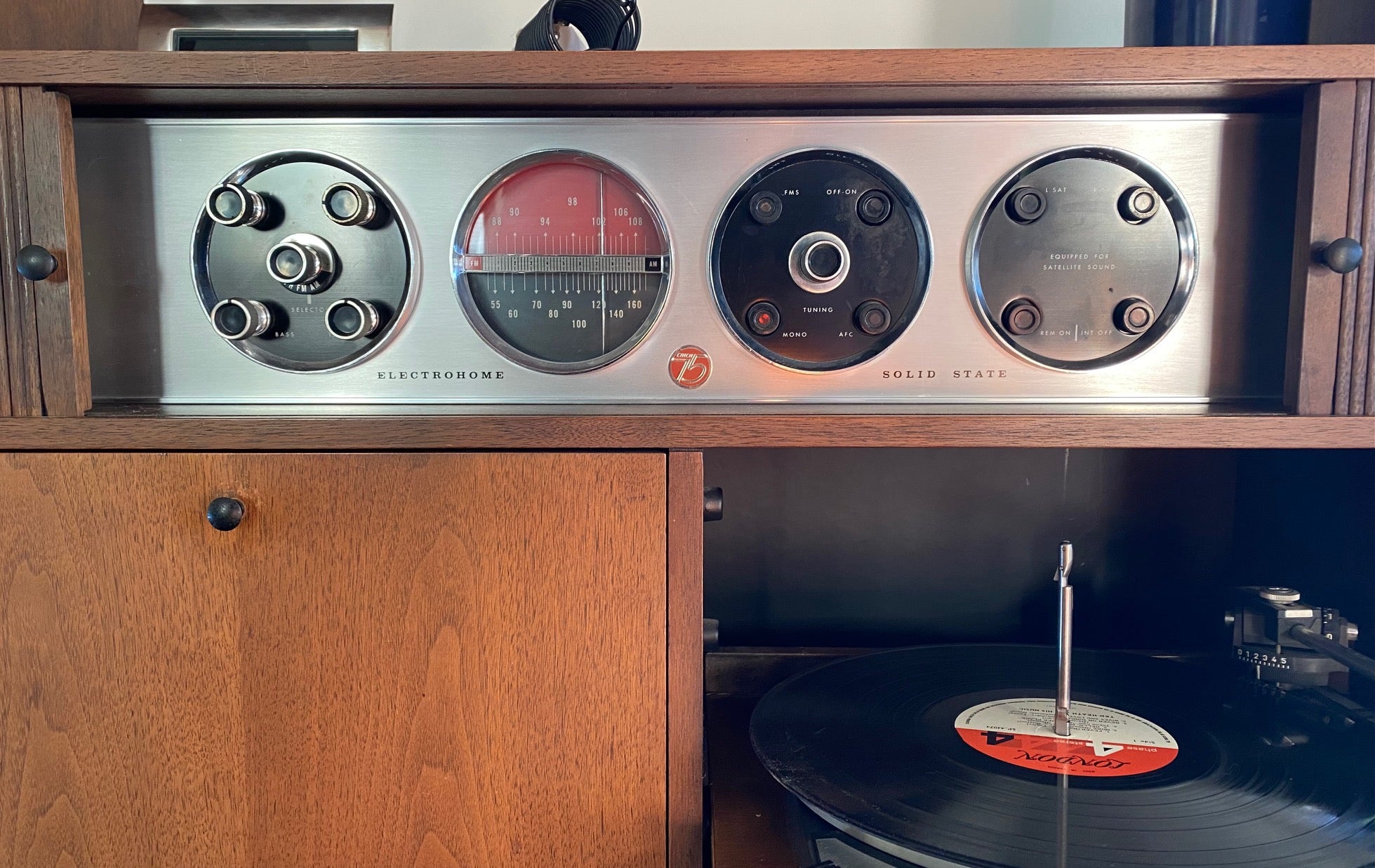 Stereo dials for Very cool Electrohome Stereo Cabinet with turntable, AM/FM radio and vinyl storage. Tambour doors slide to discreetly hide controls and dials. Cabinet made by Deilcraft- Cook Street Vintage
