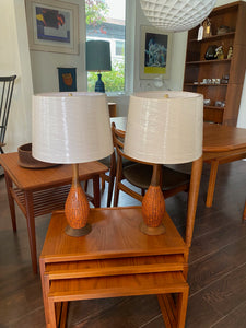 Mid-century decorative ceramic table lamps in deep orange molten glaze. Walnut neck and base. Made by Fine Arts In Plaster. (FAIP). Marked on base- Cook Street Vintage