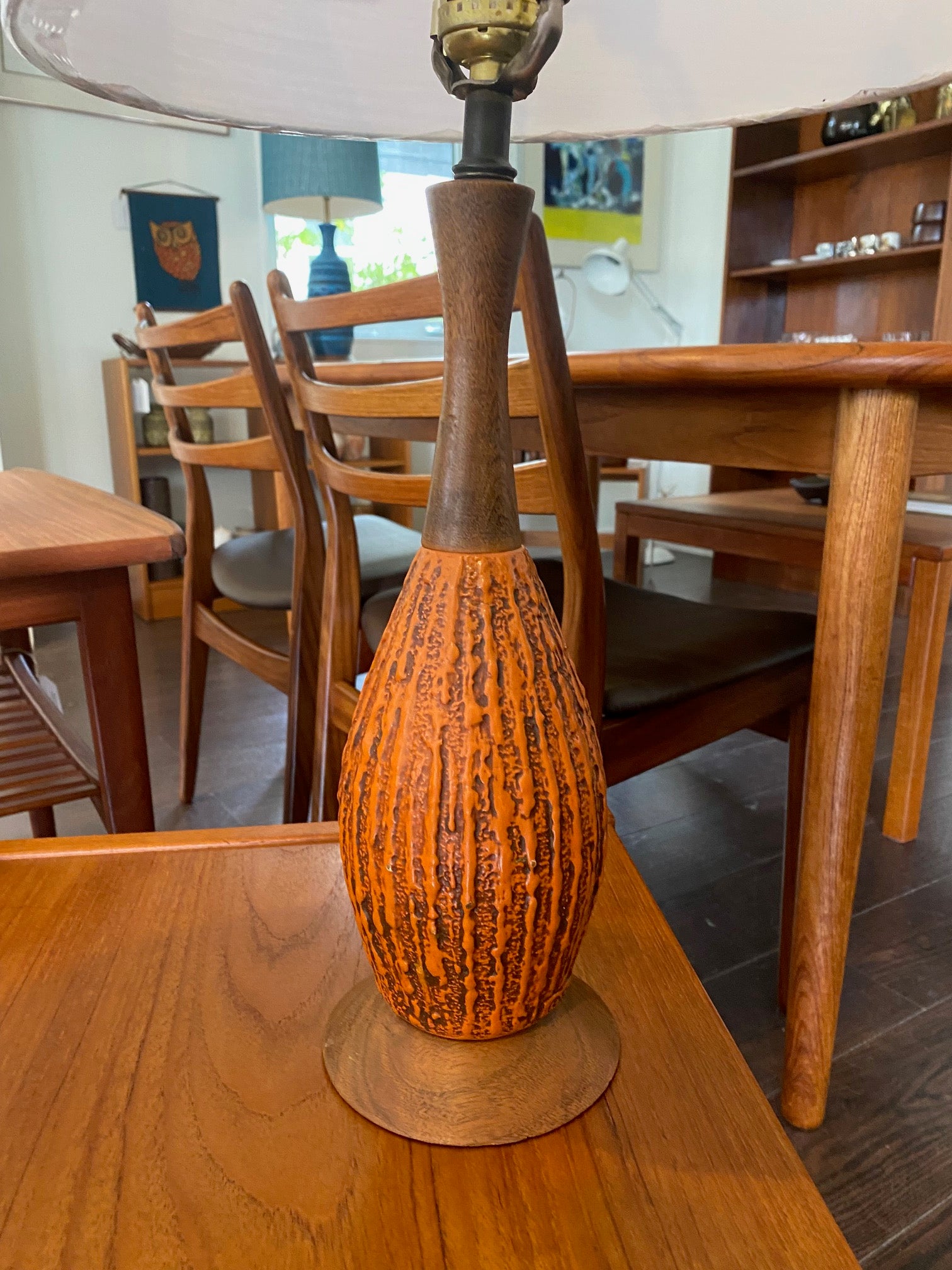 Mid-century decorative ceramic table lamps in deep orange molten glaze. Walnut neck and base. Made by Fine Arts In Plaster. (FAIP). Marked on base- Cook Street Vintage