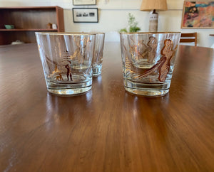 Set of four like-new low ball drinking glasses with pheasants and hunters. Images and gold on rim in excellent condition. Made in the USA by Dominion- Cook Street Vintage
