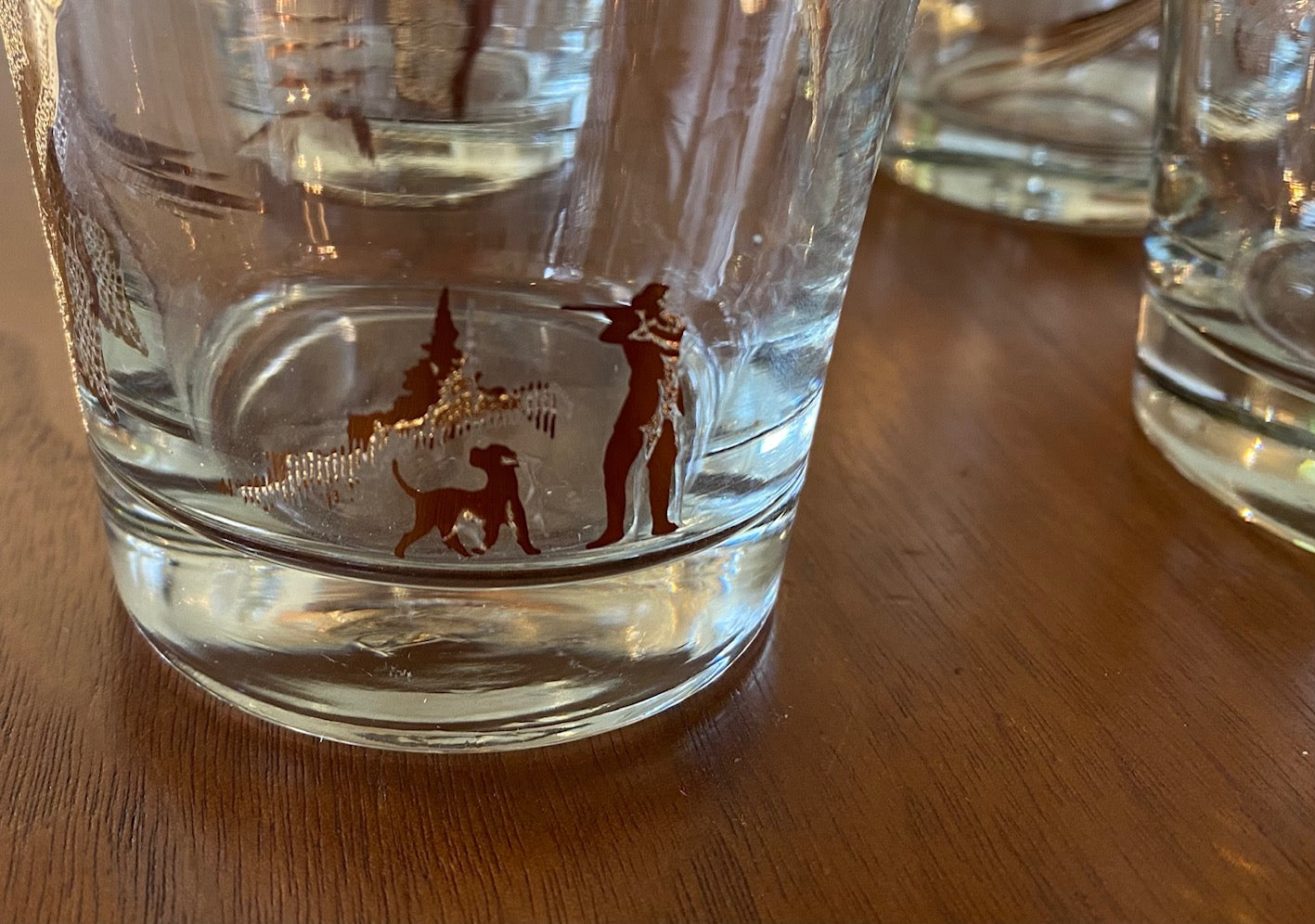 Detail of hunter on Set of four like-new low ball drinking glasses with pheasants and hunters. Images and gold on rim in excellent condition. Mad ein the USA by Dominion- Cook Street Vintage