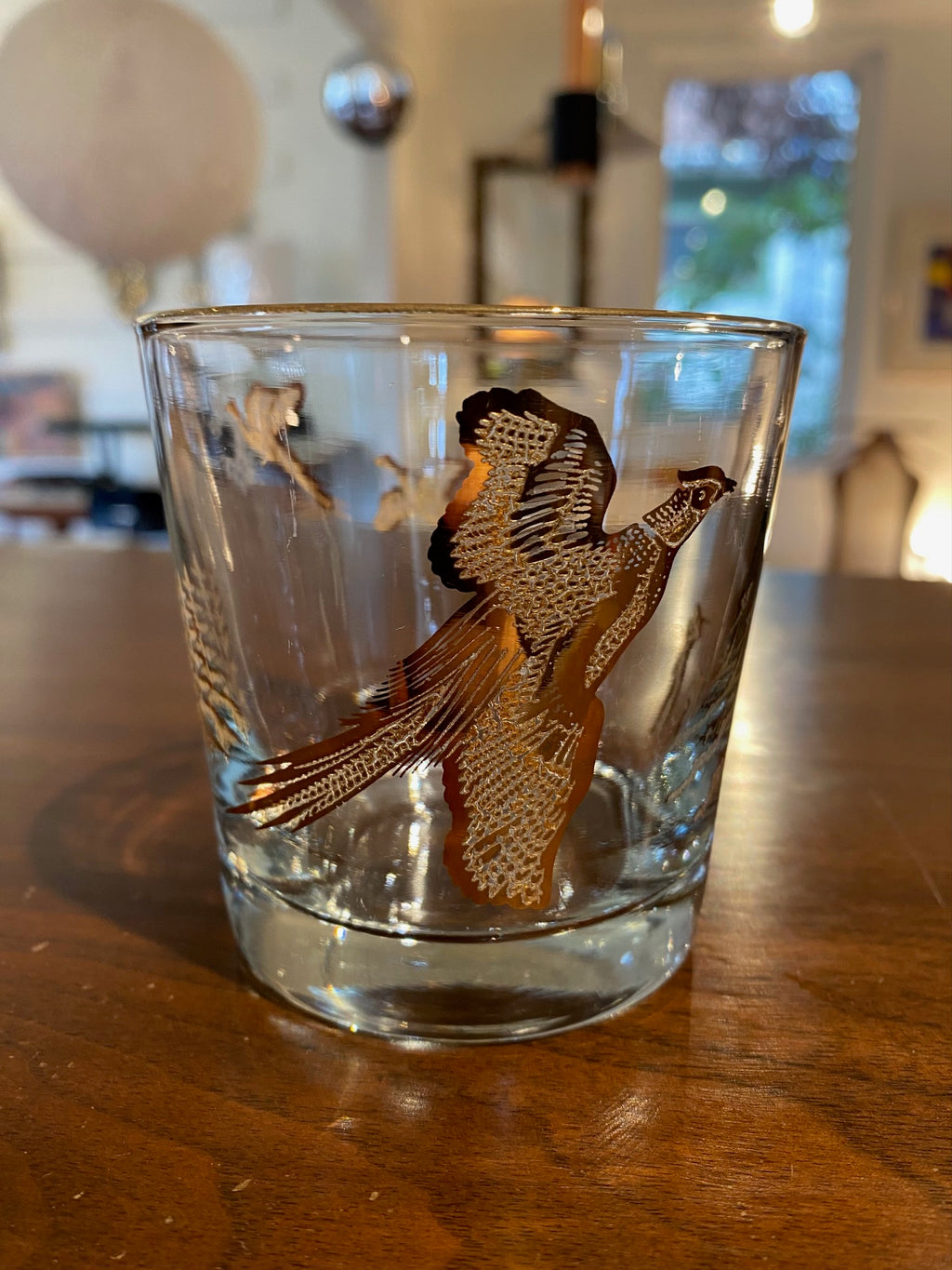 Set of four like-new low ball drinking glasses with pheasants and hunters. Images and gold on rim in excellent condition. Made in the USA by Dominion- Cook Street Vintage