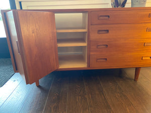 Very pretty 4 drawer sideboard with folding, sliding cabinet door. Two adjustable height shelves. Made in Denmark by Poul Hundevad. Stamped on reverse, with sliding door open- Cook Street Vintage