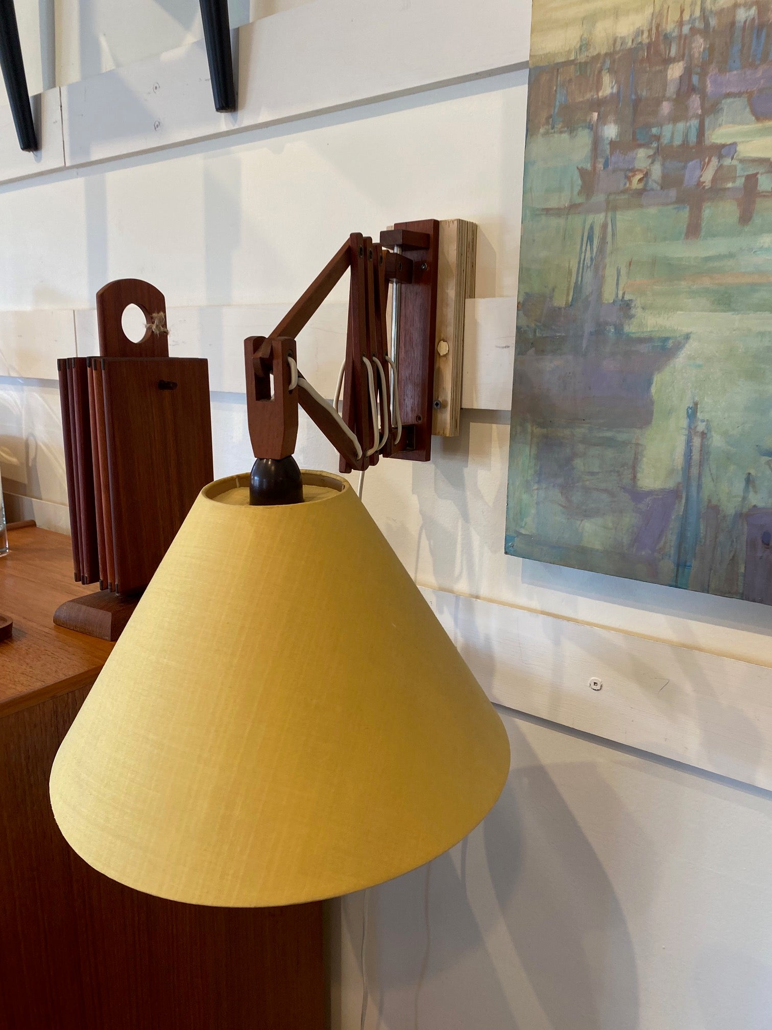 Detail on one mid-century articulating extending wall mounted lamp with yellow linen fabric shades- Cook Street Vintage