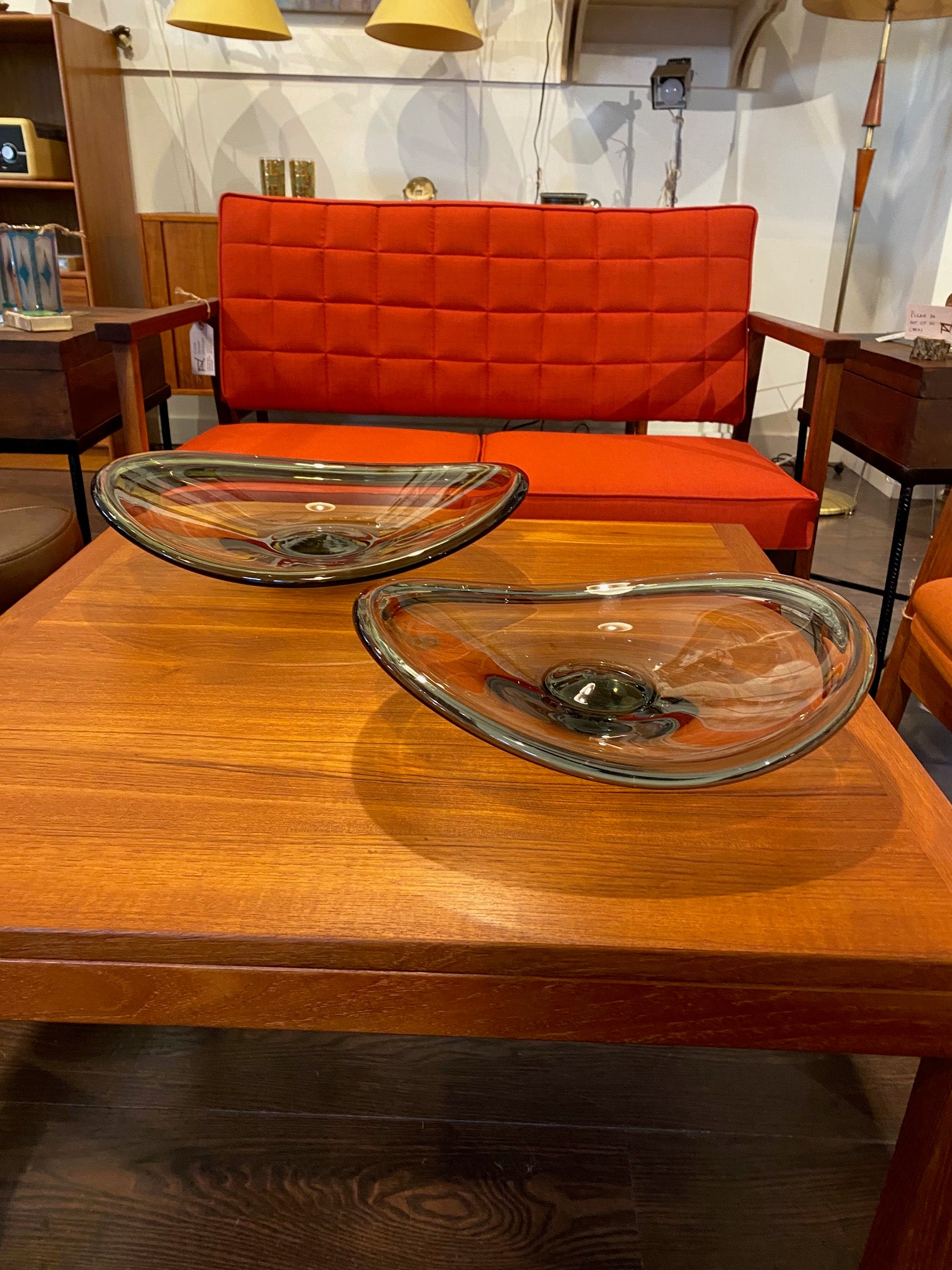 Two Beautiful mid-century Selandia glass bowls designed by Per Lutken for Holmegaard. Dark orange MMCM walnut loveseat in background- Cook Street Vintage