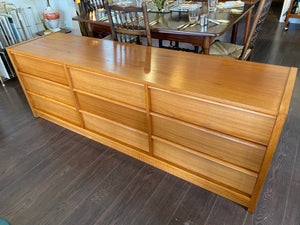 Scandinavian Modern design modern teak bedroom dresser by Feldballes Møbelfabrik. Nine hardwood drawers with sift curved pulls. Made in Denmark- Cook Street Vintage.