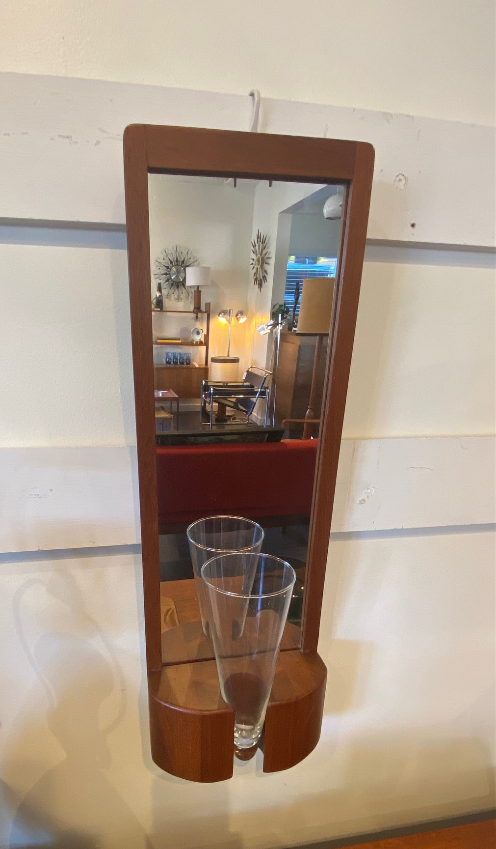 Jacob Hermann teak wall mirror. This mirror would have had a n original coloured vase which has gine missing over the years. But the mirror remains in beuaitful condition and is just as stunning without the vase. Made in Denmark by Randers Møbelfabrik-Cook Street Vintage