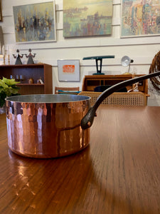 Hammered copper saucepan with cast iron handle. This beautiful pot is of the highest quality with chef's grade 200 cl thickness. The cast iron has leaked onto copper side which can be cleaned prior to use. See images.

Durable 2mm-gauge copper provides superior heat conductivity and temperature control.&nbsp;Professional-quality 18/10 stainless-steel interiors are durable, nonreactive and easy to clean. Cast-iron handles are angled for comfort. Made in France&nbsp; by Mauviel- Cook Street Vintage