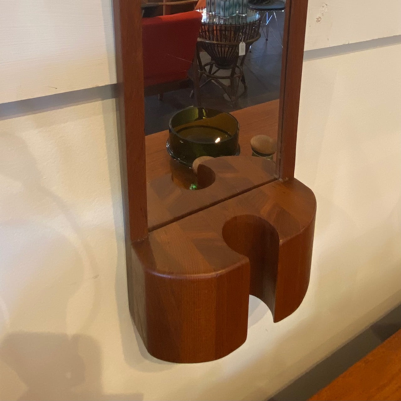 Jacob Hermann teak wall mirror. This mirror would have had a n original coloured vase which has gine missing over the years. But the mirror remains in beuaitful condition and is just as stunning without the vase. Made in Denmark by Randers Møbelfabrik-Cook Street Vintage