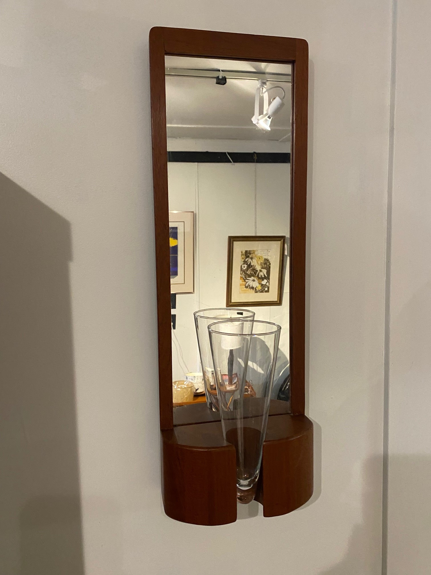 Jacob Hermann teak wall mirror. This mirror would have had a n original coloured vase which has gine missing over the years. But the mirror remains in beuaitful condition and is just as stunning without the vase. Made in Denmark by Randers Møbelfabrik-Cook Street Vintage