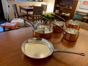 Gorgeous set of copper cookware with cast iron handles. Durable 2mm-gauge copper (200 cl thickness) provides superior heat conductivity and temperature control. Professional-quality 18/10 stainless-steel interiors are durable, nonreactive and easy to clean. Cast-iron handles are angled for comfort. Made in France by Mauviel- Cook Street Vintage