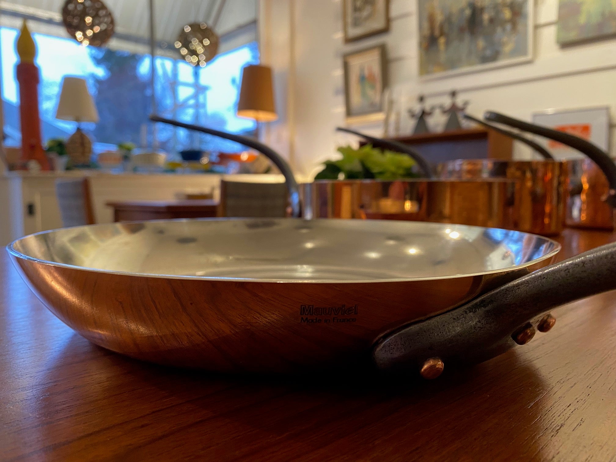 Gorgeous copper fry pan with cast iron handle. Durable 2mm-gauge copper (200 cl thickness) provides superior heat conductivity and temperature control. Professional-quality 18/10 stainless-steel interiors are durable, nonreactive and easy to clean. Cast-iron handles are angled for comfort. Made in France&nbsp; by Mauviel- Cook Street Vintage