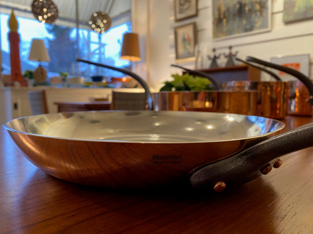 Gorgeous copper fry pan with cast iron handle. Durable 2mm-gauge copper (200 cl thickness) provides superior heat conductivity and temperature control. Professional-quality 18/10 stainless-steel interiors are durable, nonreactive and easy to clean. Cast-iron handles are angled for comfort. Made in France&nbsp; by Mauviel- Cook Street Vintage