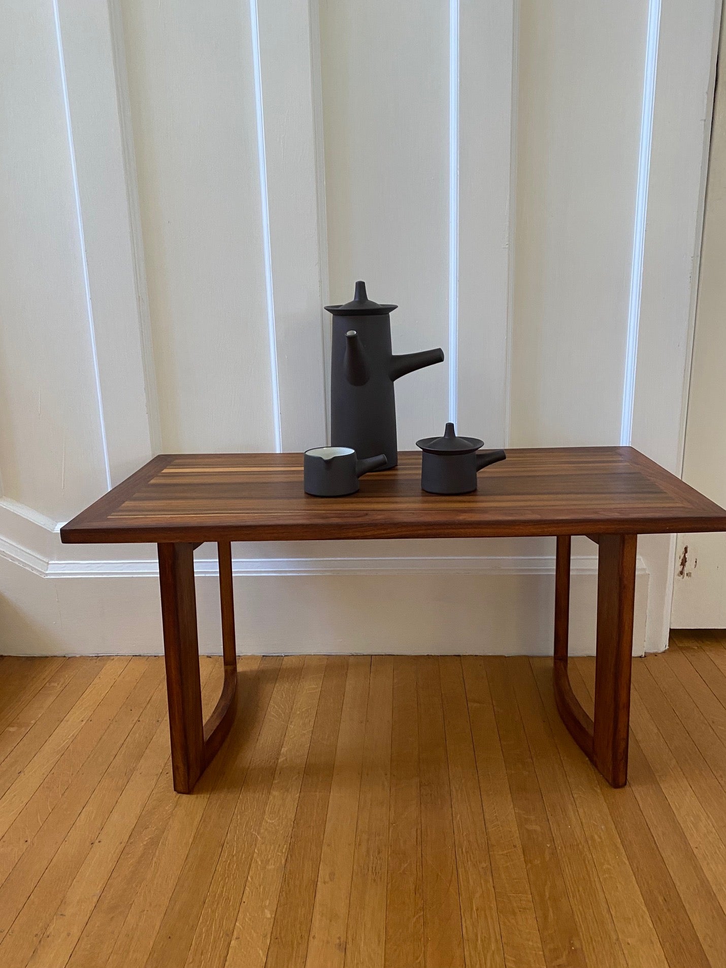 A beautiful coffee pot, creamer and sugar designed by Jens Harald Quistgaard for Dansk on walnut coffee table- Cook Street Vintage
