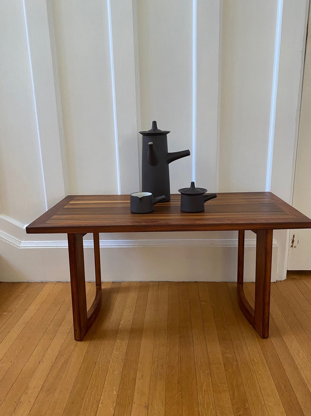 A beautiful coffee pot, creamer and sugar designed by Jens Harald Quistgaard for Dansk on walnut coffee table- Cook Street Vintage