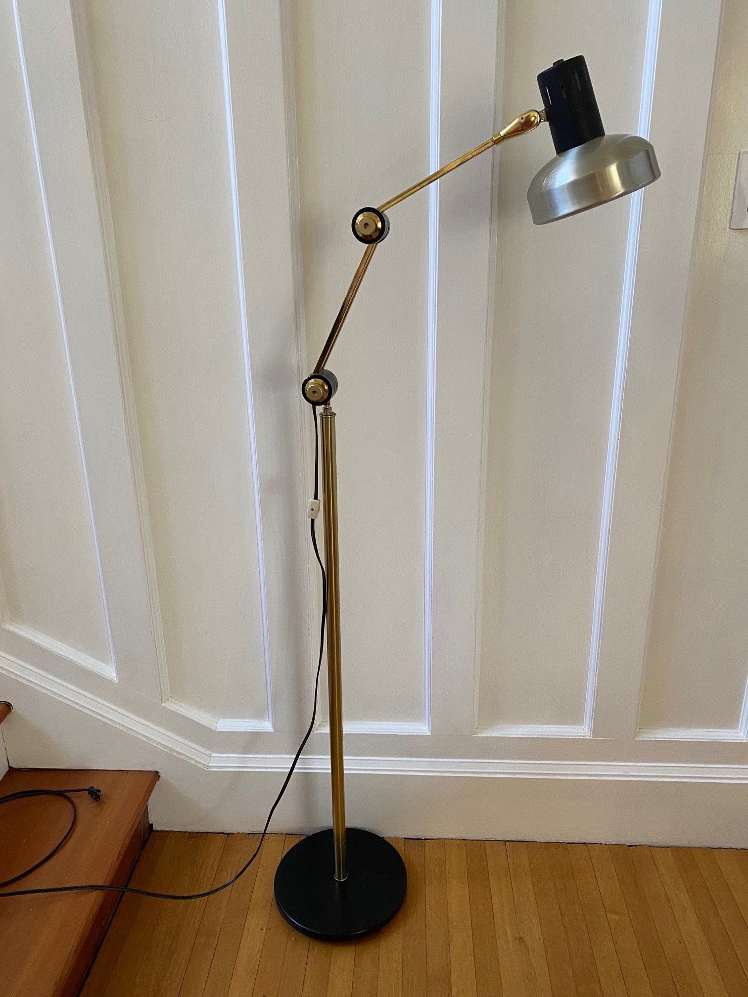 Mid-century brass floor lamp. Retro black knobs at mid-pole adjust height and direction of the lamp. Made by Ward.- Cook Street Vintage