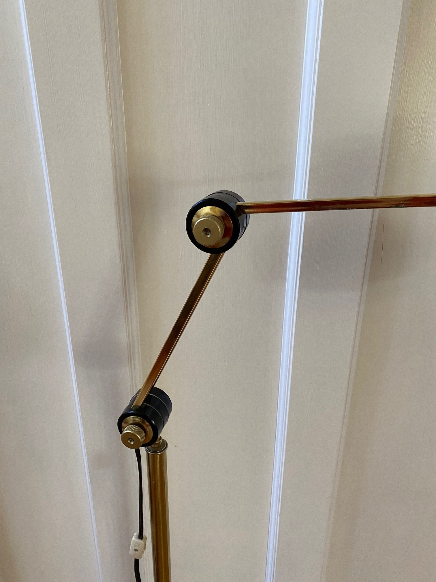 Mid-century brass floor lamp. Retro black knobs at mid-pole adjust height and direction of the lamp. Made by Ward.- Cook Street Vintage