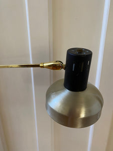 Lamp of Mid-century brass floor lamp. Retro black knobs at mid-pole adjust height and direction of the lamp. Made by Ward.- Cook Street Vintage