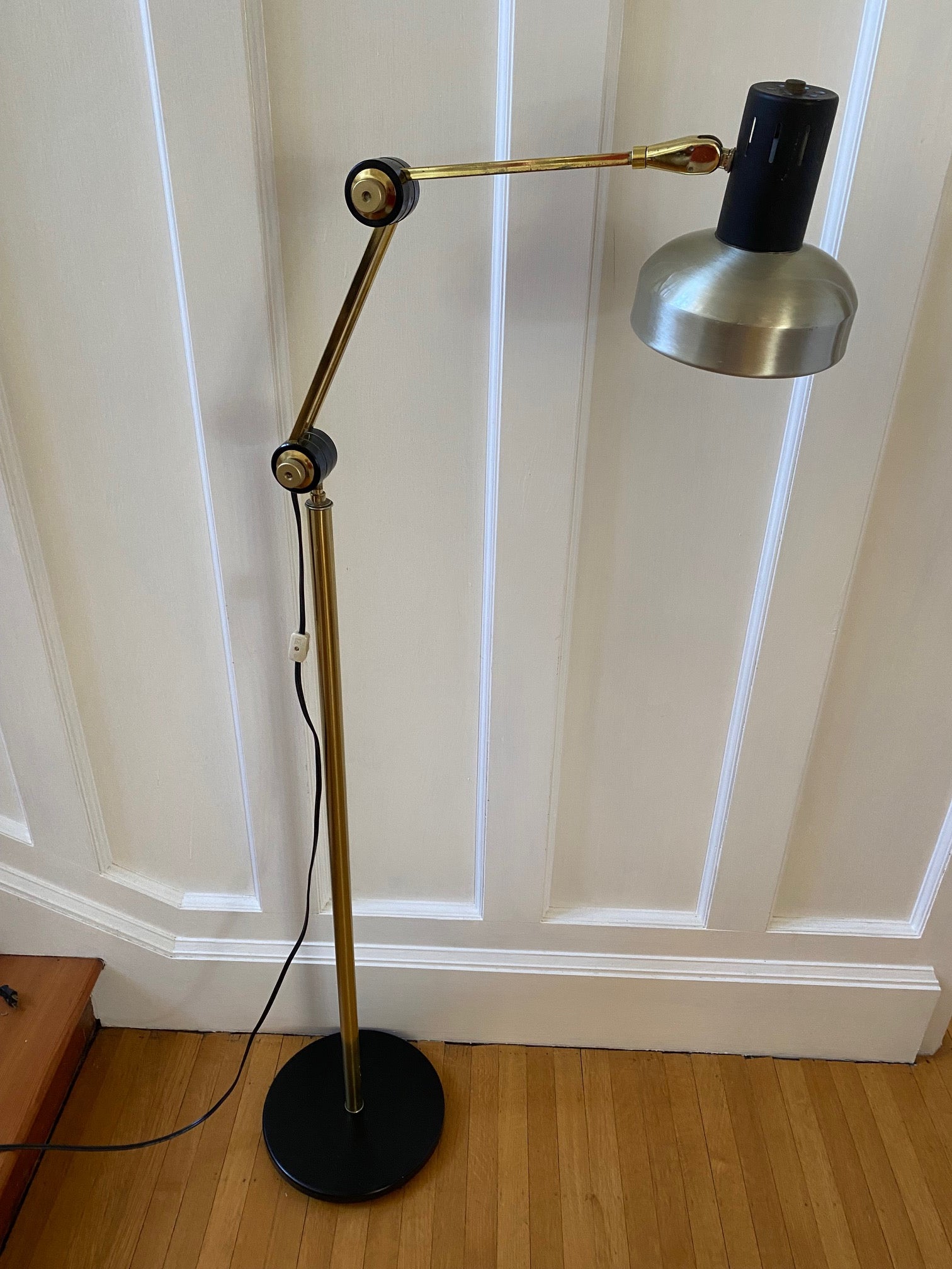 Mid-century brass floor lamp. Retro black knobs at mid-pole adjust height and direction of the lamp. Made by Ward.- Cook Street Vintage