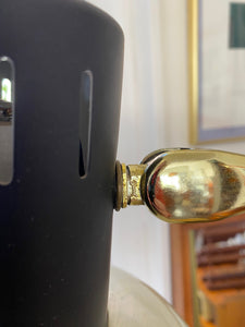 Ward Insignia on neck of Mid-century brass floor lamp. Retro black knobs at mid-pole adjust height and direction of the lamp. Made by Ward.- Cook Street Vintage
