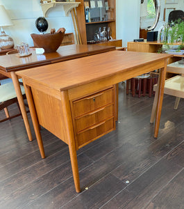 Lovely Mid-century Danish desk in teak and birch manufactured by Ejsing Møbelfabrik. Beautiful at any angle with a finished back. Three dovetailed drawers with sculpted handles. Tapered legs. The perfect fit for small spaces. Key not available. Made in Denmark- Cook Street Vintage.