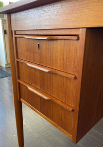 Lovely Mid-century Danish desk in teak and birch manufactured by Ejsing Møbelfabrik. Beautiful at any angle with a finished back. Three dovetailed drawers with sculpted handles. Tapered legs. The perfect fit for small spaces. Key not available. Made in Denmark- Cook Street Vintage.