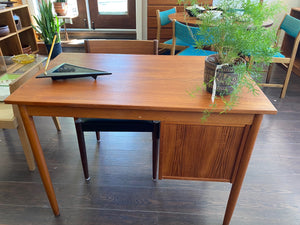 Back side showing finished side of Lovely Mid-century Danish desk in teak and birch manufactured by Ejsing Møbelfabrik. Beautiful at any angle with a finished back. Three dovetailed drawers with sculpted handles. Tapered legs. The perfect fit for small spaces. Key not available. Made in Denmark- Cook Street Vintage.