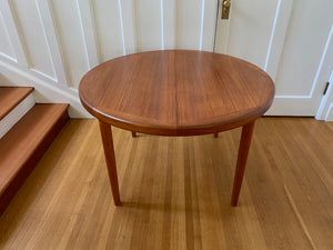 Gorgeous Mid-century honey teak round dining table. Smaller profile than our other round dining tables, this beauty has an elegant staved edge of solid teak- Cook Street Vintage