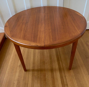 Gorgeous Mid-century honey teak round dining table. Smaller profile than our other round dining tables, this beauty has an elegant staved edge of solid teak- Cook Street Vintage