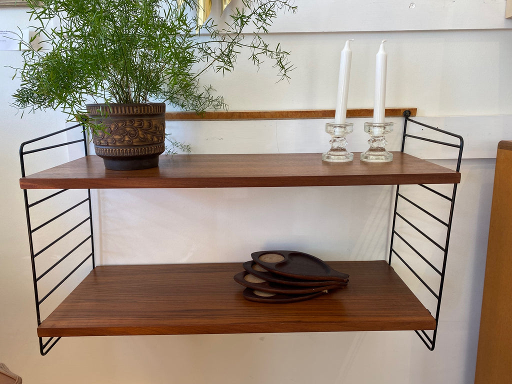 Very nice string mid-century bookshelf. Originally designed&nbsp;by Kajsa &amp; Nils "Nisse" Strinning. Metal ladder with two teak shelves. Easy hooks allow you to change shelf height- Cook Street Vintage