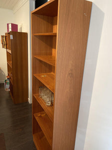 Sideview of Hundevad teak shelves with tapered edges and other teak shelves in background- Cook Street Vintage