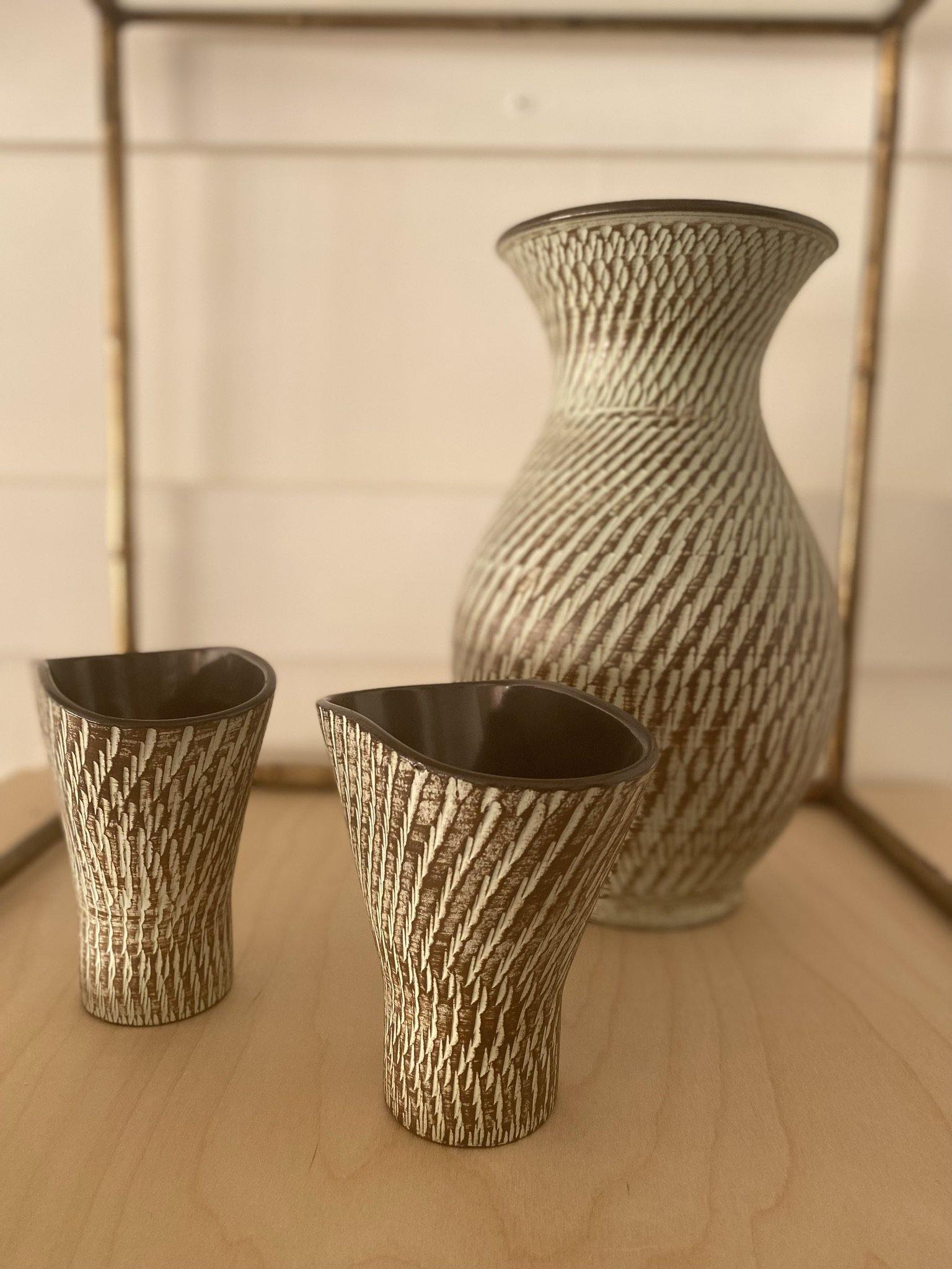 Close up of two smaller funnel shaped vases with larger vase in background- Cook Street Vintage
